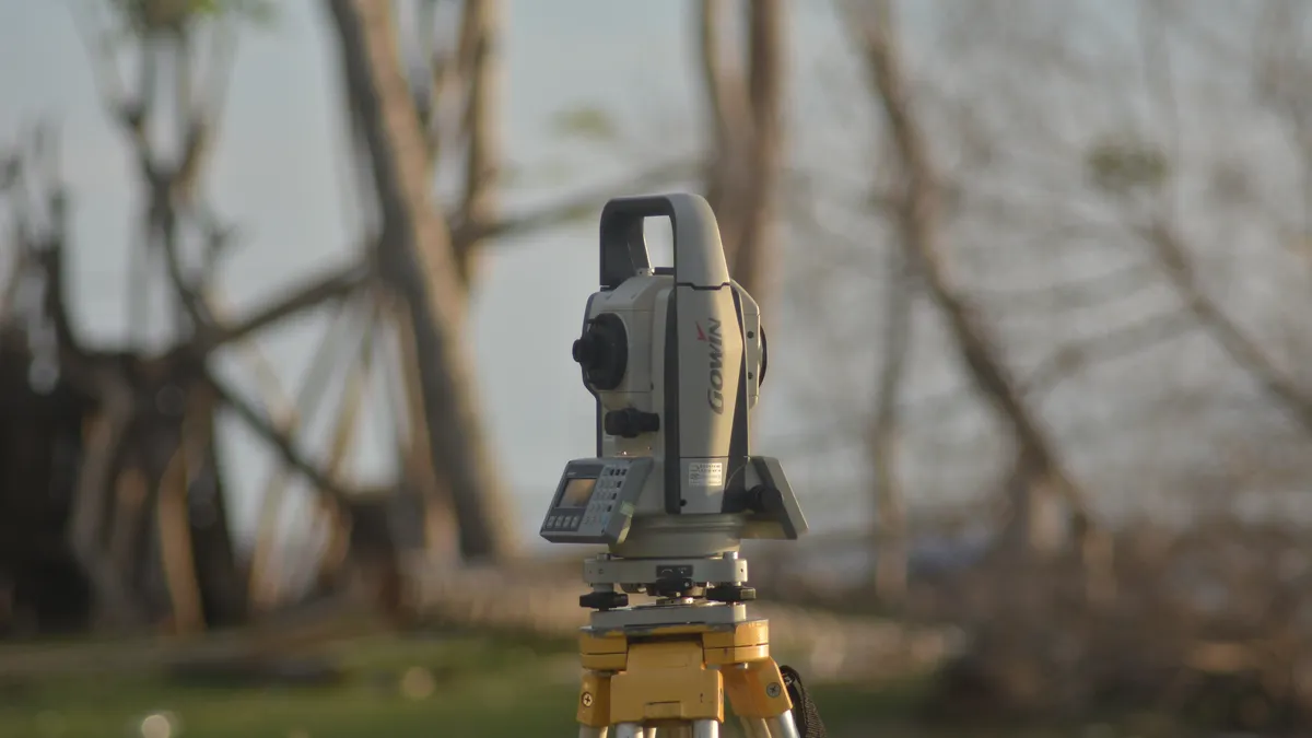 Total station surveying tool on a tripod outdoors