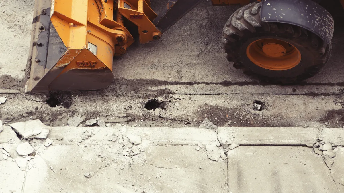 When to Use a Walk-Behind Trencher for Utility Installation Trencher cutting along pavement edge