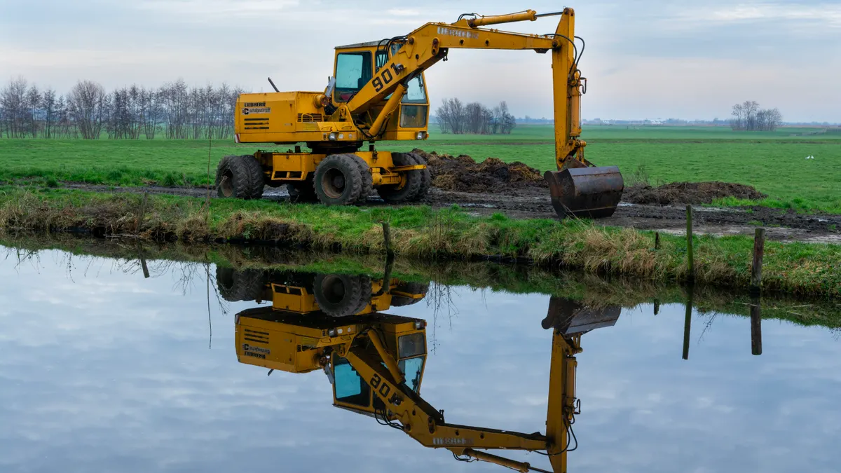 When to Use a Walk-Behind Trencher for Utility Installation Trencher working beside a wet field